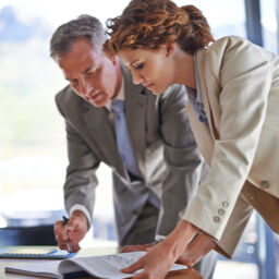 Two professionals review trust paperwork