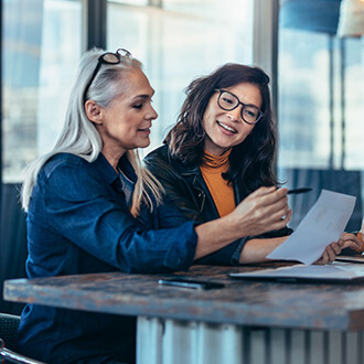 Two professionals review documents